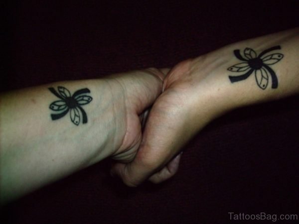 Attractive Black Flower Tattoo On Wrist
