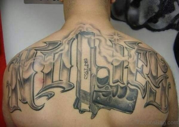 Grey Ink Gun Tattoo On Upper Back