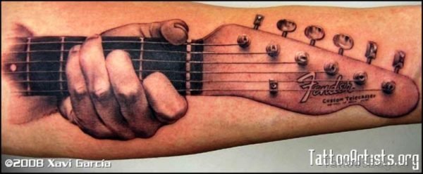 Amazing Hand Holding Guitar Tattoo