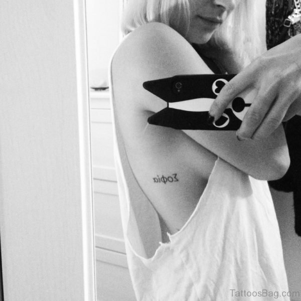 Arabic Word Tattoo On Girls Rib Image