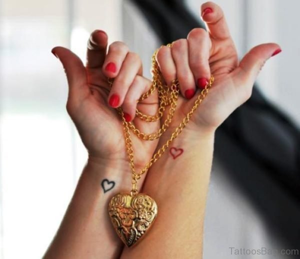 Black And Red Heart Tattoo On Wrist