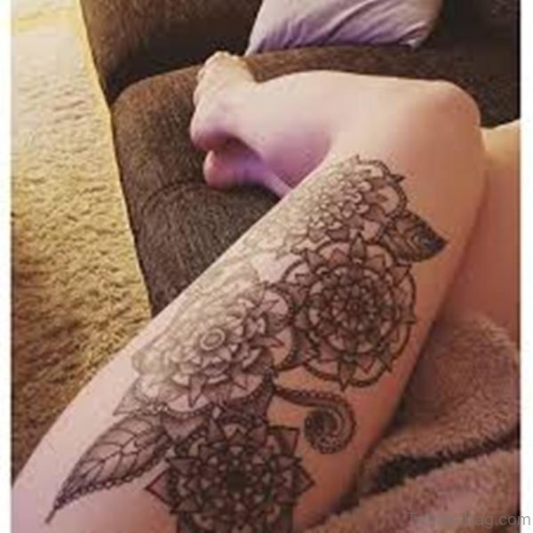Black Inked Beautiful Native Mandala Flower Tattoo On Girl Thigh