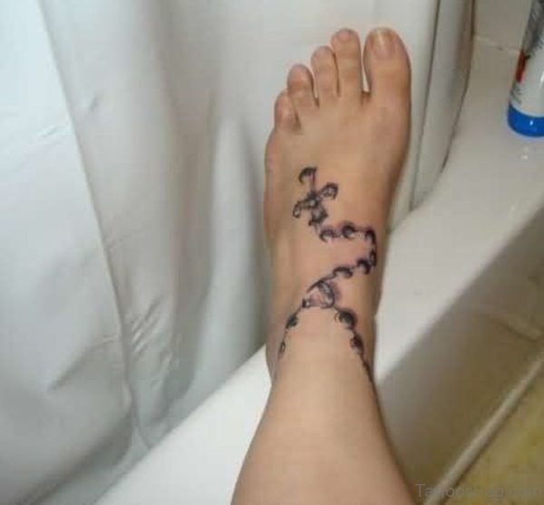 Bracelet And Cross Tattoo On Ankle