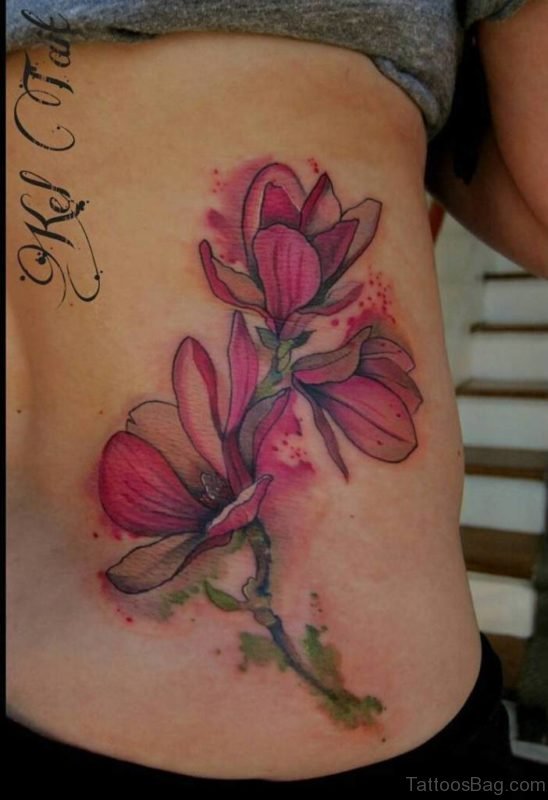 Colored Magnolia Tattoo On Lower Back