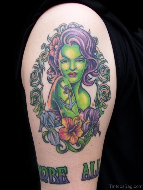 Cool colored sexy zombie girl with flowers and lettering tattoo on shoulder