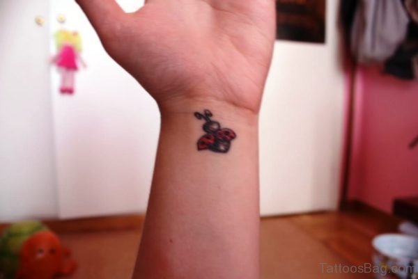 Cute Flying Ladybug Wrist Tattoo 
