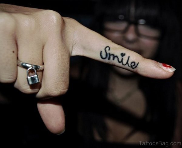Dazzling Smile Tattoo On Finger