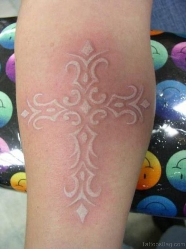 Elegant white ink cross tattoo on leg