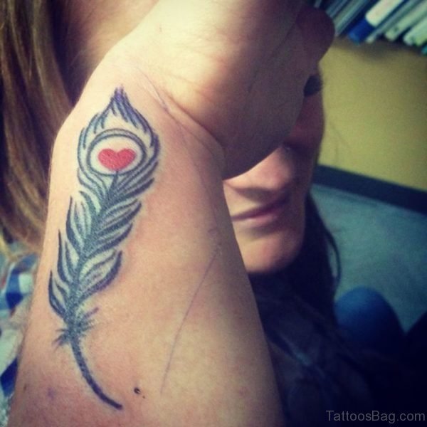 Enticing Peacock Feather Wrist Tattoo