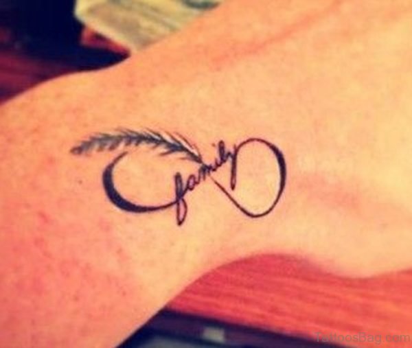 Family Text And Infinity Feather Tattoo On Wrist