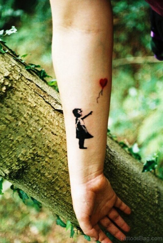 Girl Catching Balloon Tattoo On Wrist