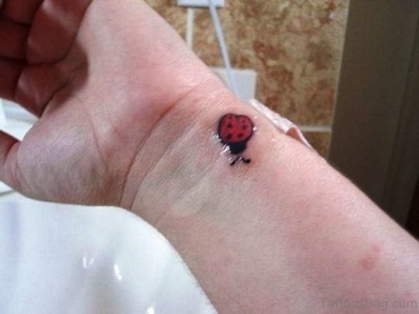 Ladybug Tattoo On Left Wrist 