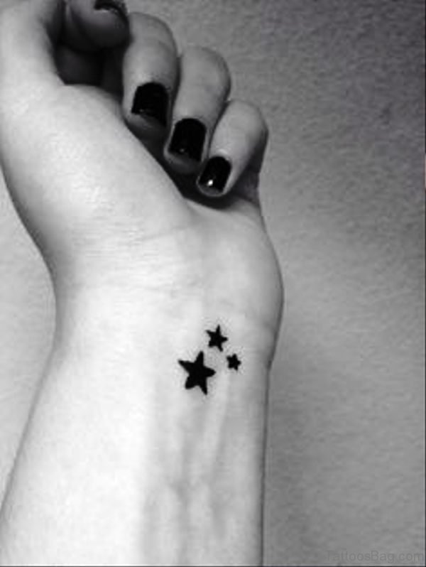 Little Black Stars Tattoo On Wrist