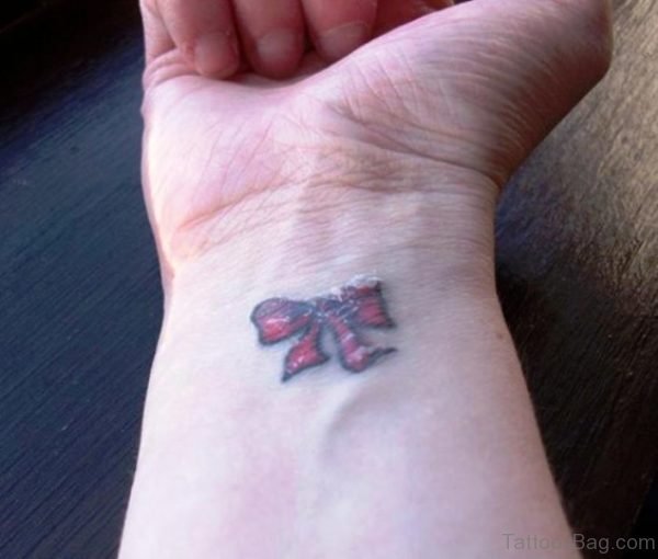 Little Red Bow Tattoo On Wrist