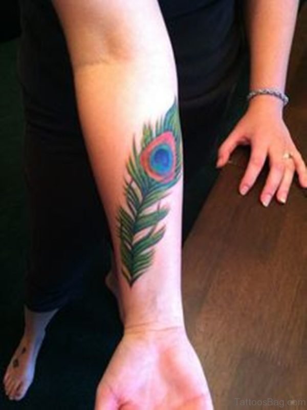 Nice Green Peacock Feather Tattoo On Wrist