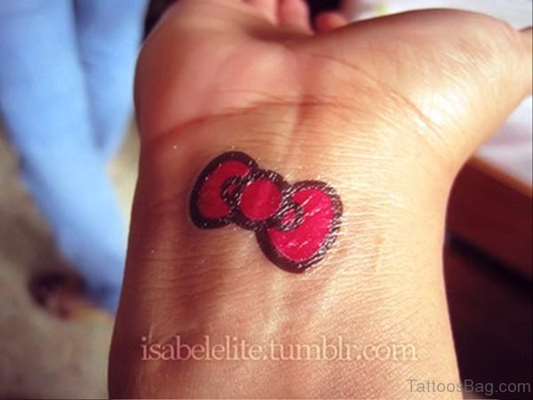 Red Kitty Bow Tattoo On Wrist