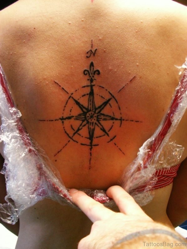 Showing Black Compass Tattoo On Back