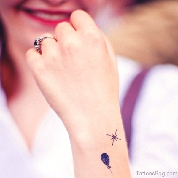 Small Black Balloon Tattoo On Wrist