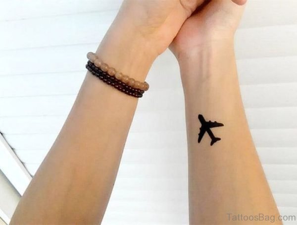 Small Black Plane Tattoo On Wrist