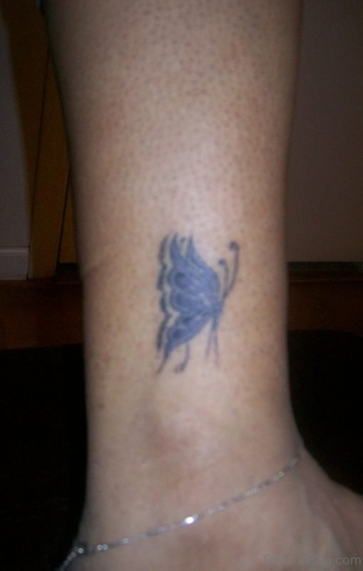 Tiny Blue Flying Butterfly Tattoo On Ankle