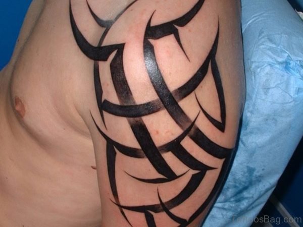 Tribal Shining Tattoo On Left Shoulder
