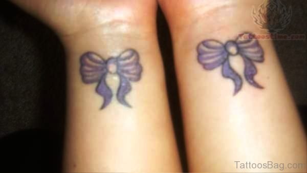 Two Purple Tattoos On Both Wrist