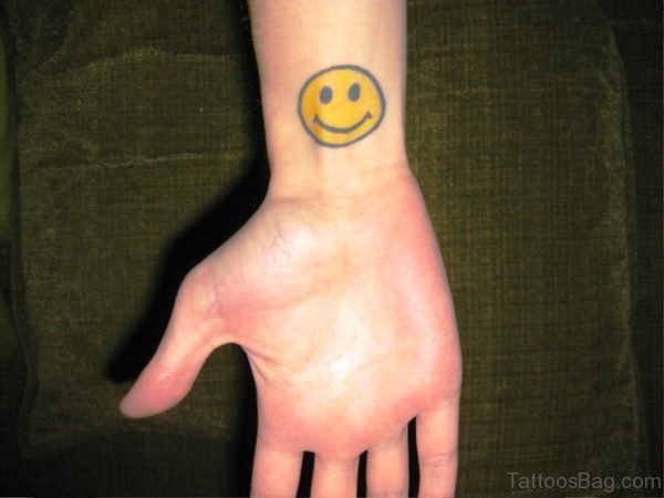 Yellow Smiley Tattoo On Wrist