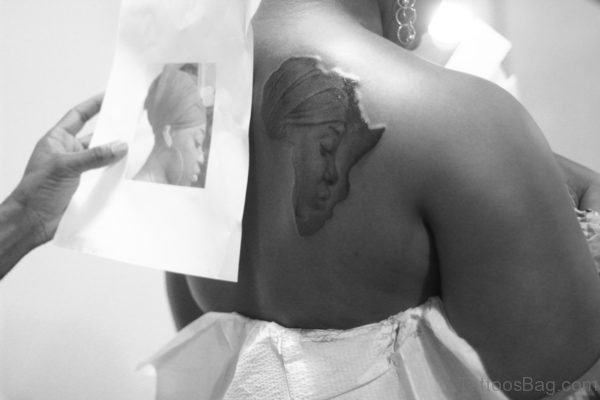 African Queen Face In Map Tattoo On Bach Shoulder