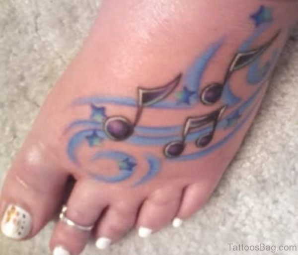 Blue Colored Musical Note Tattoo On Foot