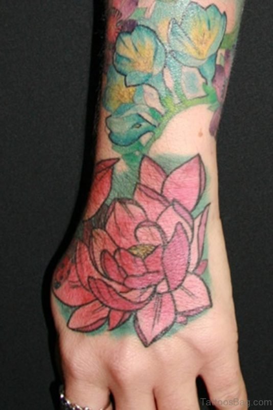Pink Lotus And Reptile Eyes Tattoo On Hand