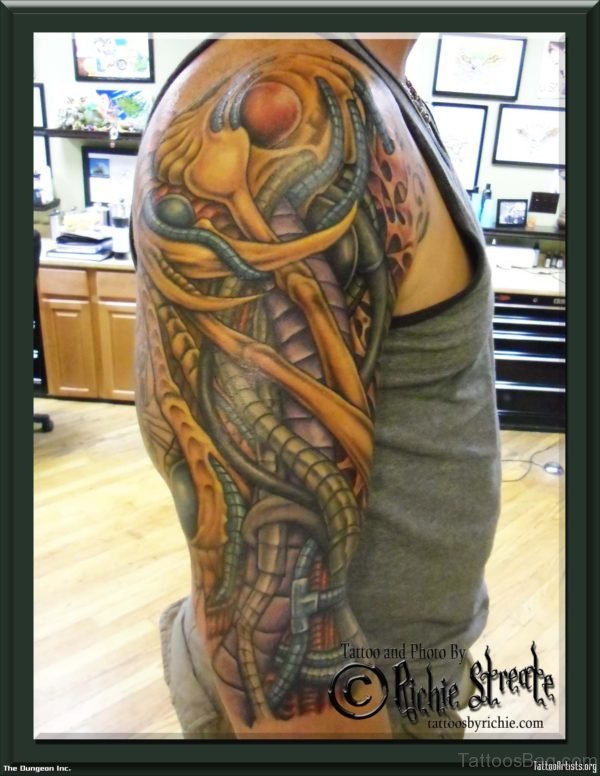 Yellow Bio Mechanical Tattoo On Shoulder