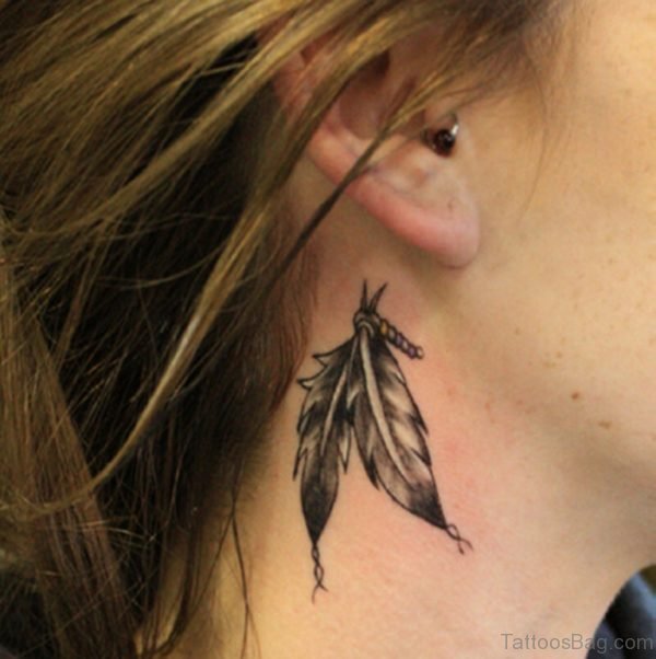 Small feather tattoo on neck
