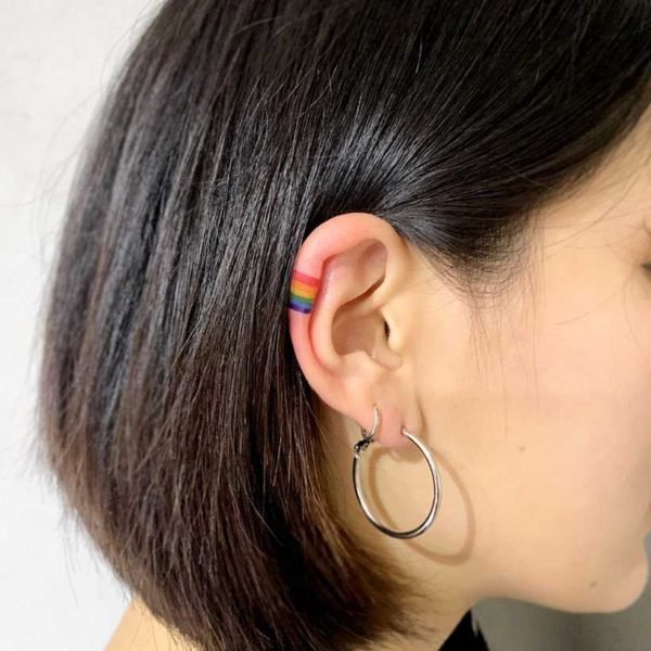 Tiny Rainbow Tattoo On The Right Ear