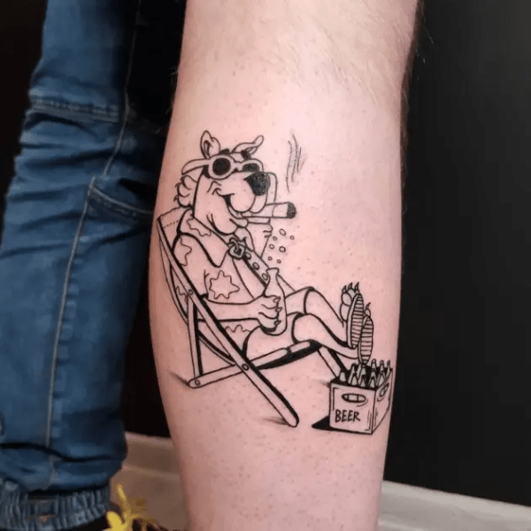 Enjoying On Beach Scooby Doo Tattoo